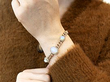 opal cluster bracelet in gold on wrist