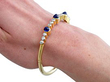 wearing gold sapphire and diamond bangle