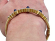 gold sapphire and diamond bangle on wrist
