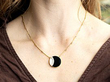 wearing a round onyx pendant
