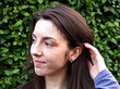 wearing diamond and gold earrings