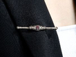 wearing a ruiby and diamond bar brooch
