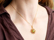 wearing a gold peridot pendant
