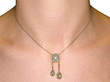 wearing emerald and diamond pendant