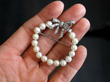 Holding Vintage Pearl Diamond and White Gold Brooch