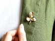 wearing diamond gold leaf brooch