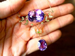 holding amethyst pendant in hand