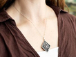wearing onyx and diamond pendant