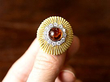 holding large garnet cocktail ring