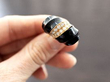 holding gold onyx ring
