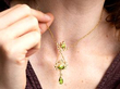 wearing pearl and peridot pendant