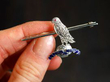 Diamond and Ruby Regimental Brooch in White Gold Holding
