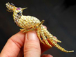 Holding Yellow Gold and Gemstone Peacock Brooch