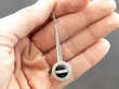 holding onyx and diamond pendant
