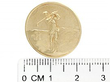 Antique gold buttons next to ruler