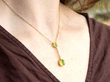 peridot drop pendant in gold on the neck