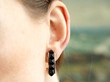 wearing rose gold and onyx hoop earrings