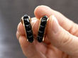 holding black onyx hoop earrings