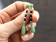 holding jade drop earrings