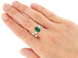 wearing Oval Cut Emerald and Diamond Ring in Platinum
