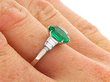 Oval Cut Emerald and Diamond Ring in Platinum wearing