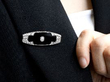 wearing a onyx brooch with diamonds