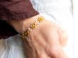 wearing a gold peridot bracelet