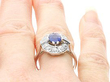 Oval Sapphire Cluster Ring with Baguette Side Stones on finger