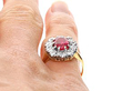 wearing Cushion Cut Ruby and Diamond Cluster Ring