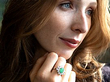 wearing an emerald and diamond cluster ring