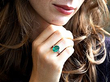 wearing an oval emerald ring