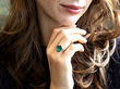 an oval emerald ring on the hand