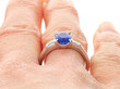 Oval Sapphire Ring with Diamond Shoulders on finger