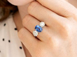 Cushion Cut Sapphire Trilogy Ring in Platinum wearing