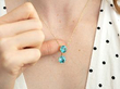 wearing Blue Zircon Pendant in Yellow Gold