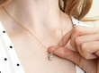 antique solitaire pendant on rose gold chain on neck