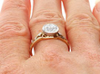 Bezel Set Round Engagement Ring in Gold being worn