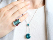 wearing zircon pendant and aquamarine ring