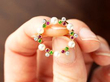 holding gemstone wreath brooch