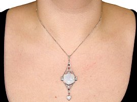 wearing an opal pendant