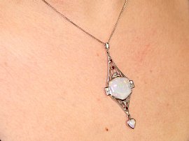 close up of opal pendant on neck