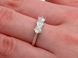 platinum three stone ring on finger