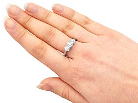 platinum three stone diamond ring on hand