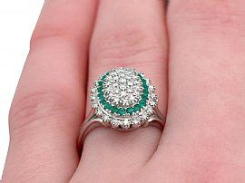 wearing a diamond and emerald cocktail ring