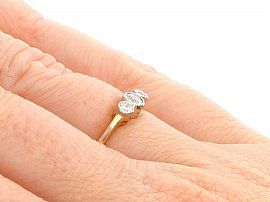 Three Stone Diamond Ring in Yellow Gold Wearing Hand
