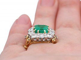 Large Emerald and Diamond Cluster Ring Wearing Finger