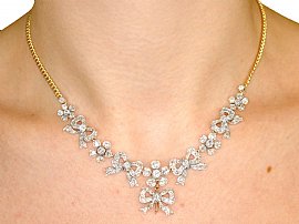 wearing diamond bow necklace