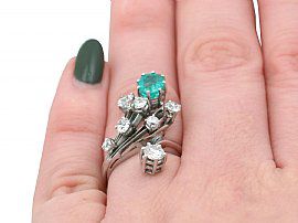 Emerald and Diamond Ring on Finger
