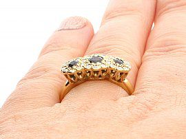Sapphire and Diamond Yellow Gold Ring Wearing Finger