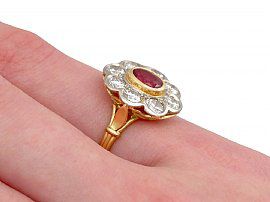 ruby and diamond cluster ring on the hand